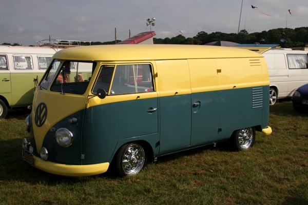 Yellow and green splitty in camping area