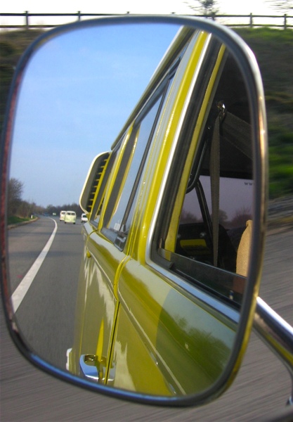 View from the rear-view mirror - a convoy of buses on the M4